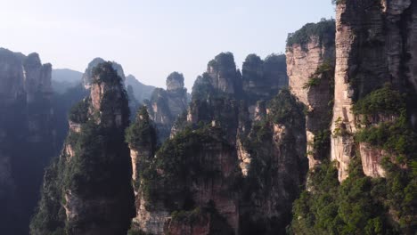 Aerial-view-of-epic-Zhangjiajie-stone-pillars-at-sunset-time