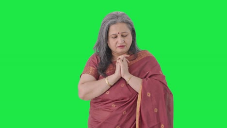 Religious-Indian-old-woman-praying-Green-screen