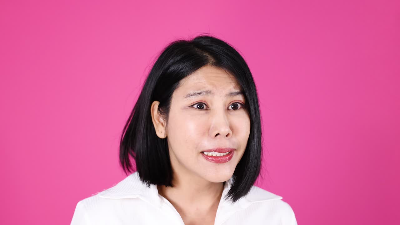 Woman in white shirt talks, gestures, and displays varied emotions, studio lighting, static camera
