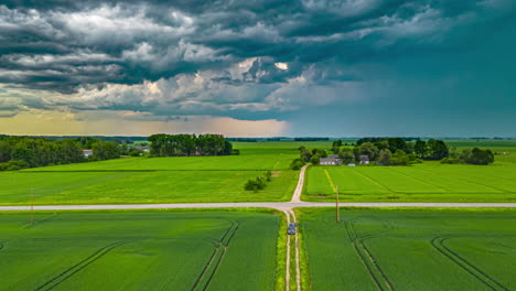 Vast-Scenery-Of-Farmlands-With-Wooden-Cabins-Near-Roads-During-Cloudy-Day