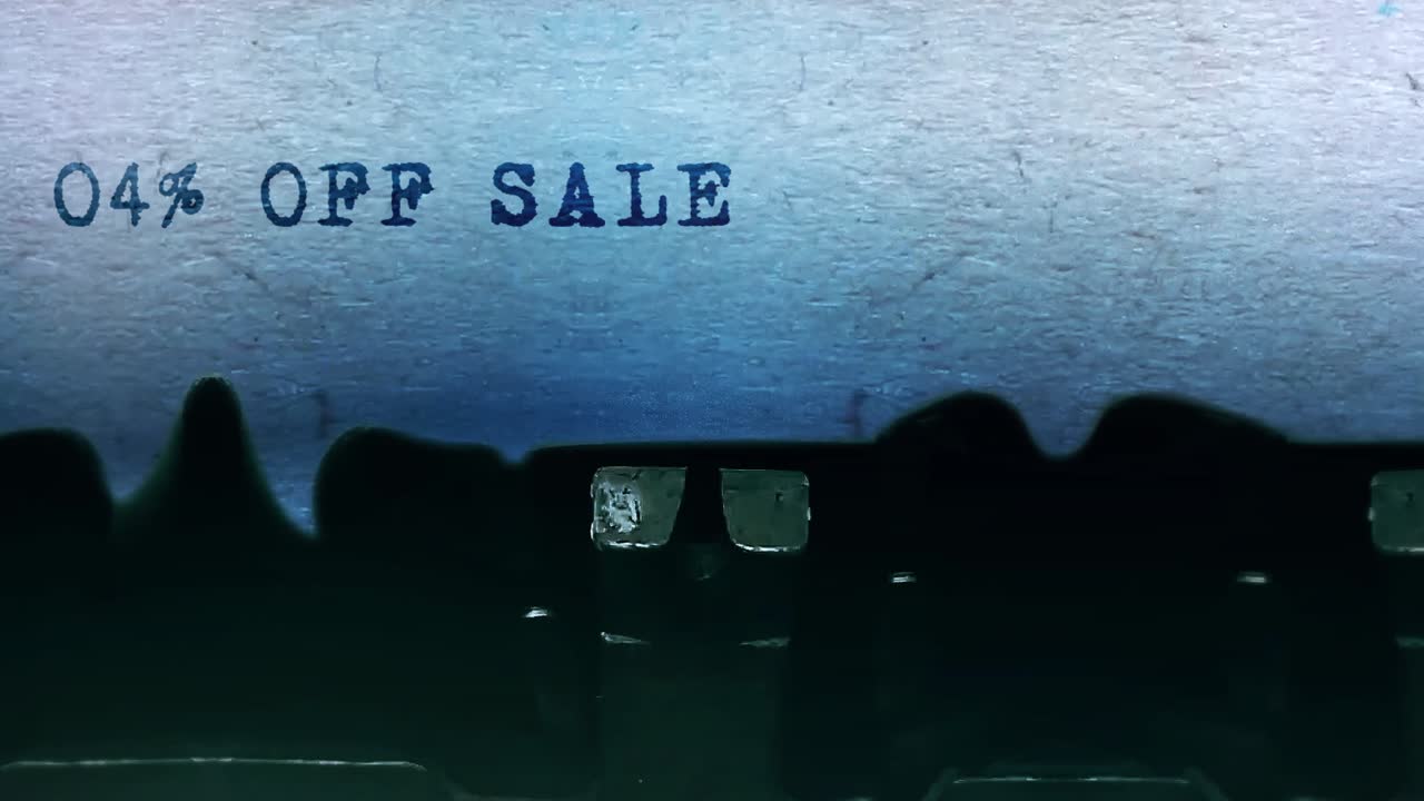 04 off sale word closeup being typing and centered on a sheet of paper on old vintage typewriter