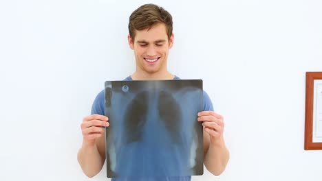 Smiling-patient-showing-his-positive-xray