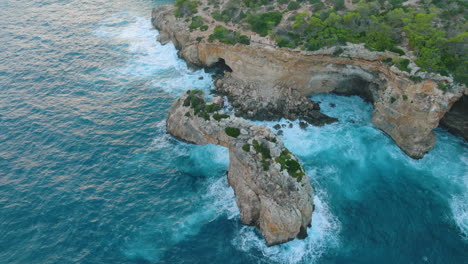 coastal arch with waves and people