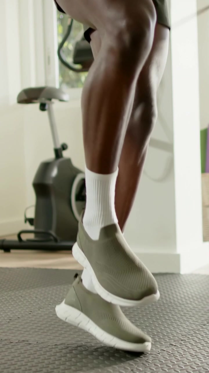 Vertical video: Performing footwork man doing rope drills on mat in gym, in olive shoes for fitness