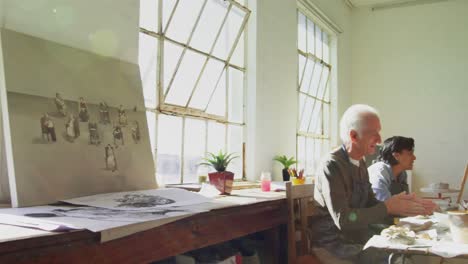 artist molding a clay at table 4k