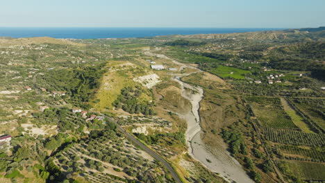 a dry river in calabria flows towards the mediterranean sea due to drought