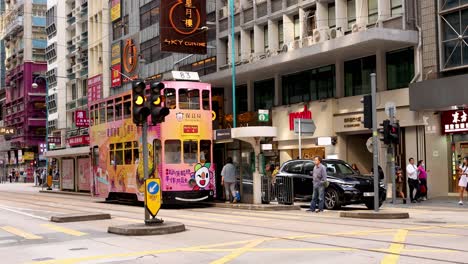 tram moving through busy city intersection