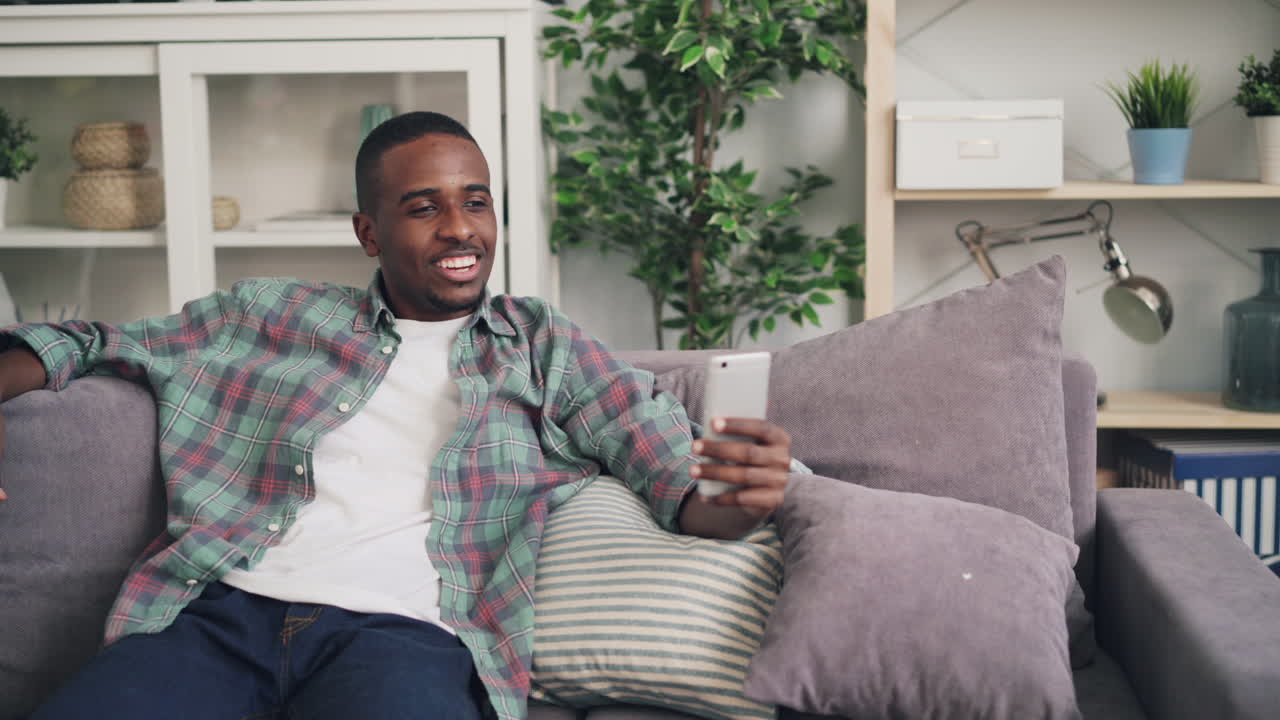 Man using smartphone on a couch