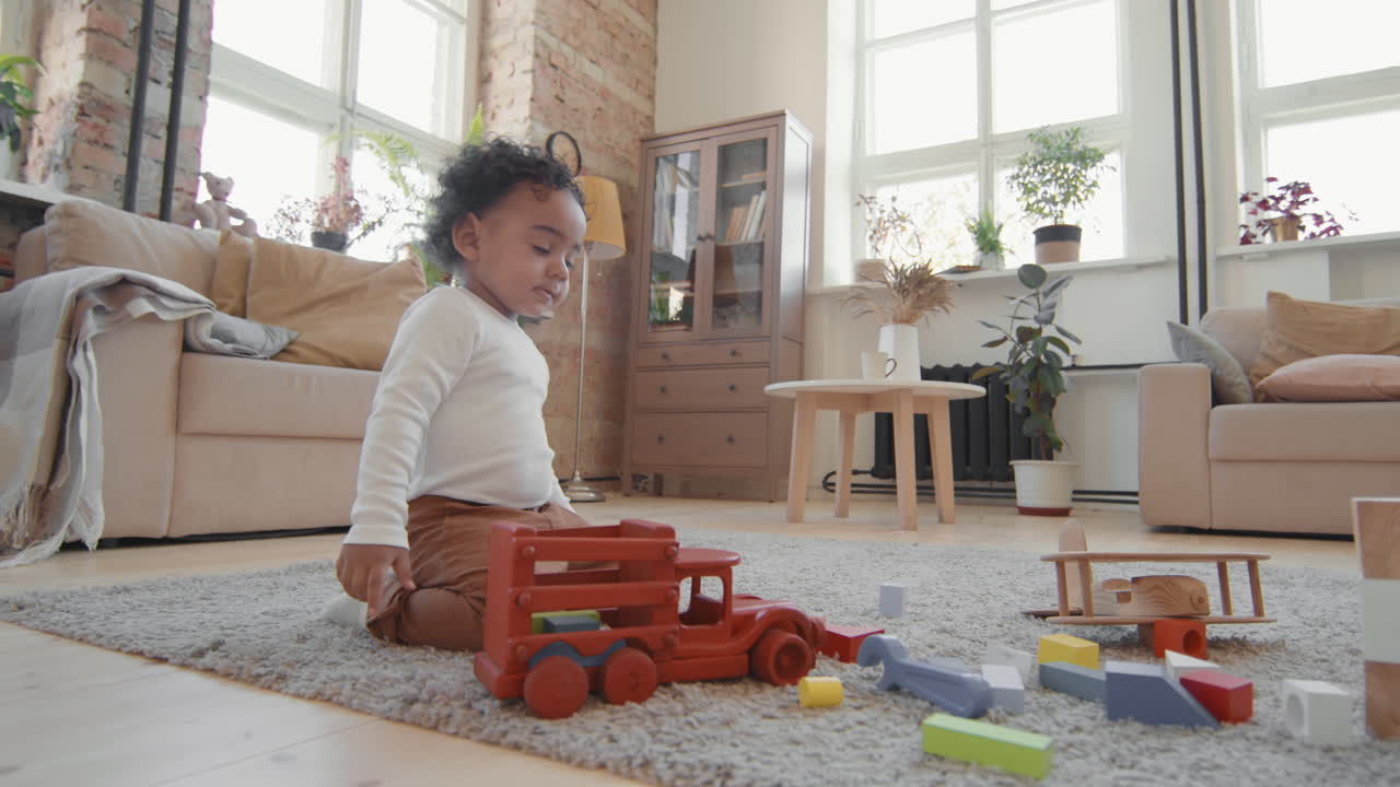 Adorable Little Boy Playing with Toys in Living Room
