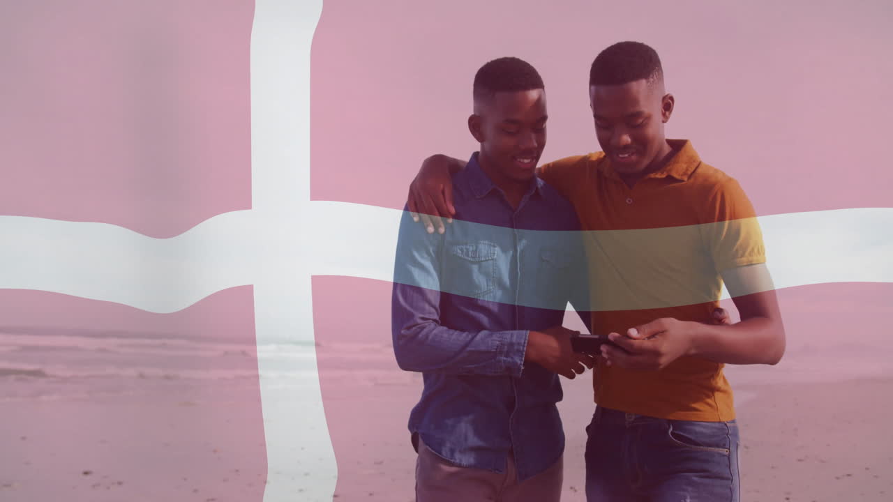 Walking on beach, two people with Denmark flag animation overlay