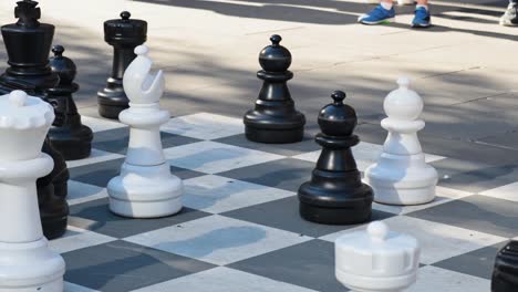 people playing giant chess in a public space