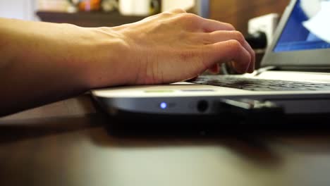 Close-up-of-womens-hands-typing-and-using-a-silver-laptop