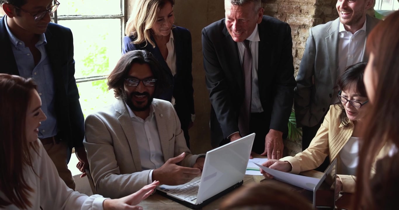 Diverse Business Team Collaborating on Project in Modern Office