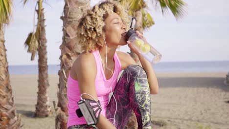 trendy slender young woman drinking water