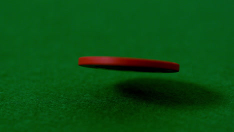 casino chip falling on green table