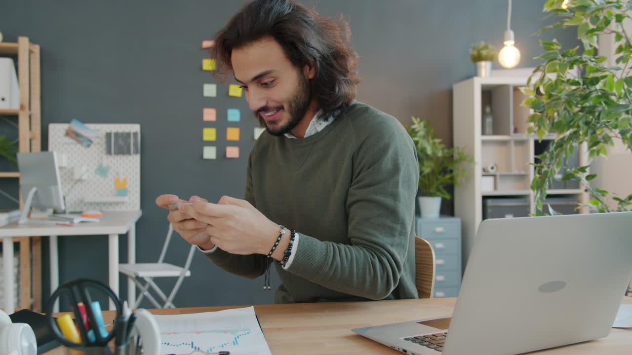 Man Using Smartphone in Office