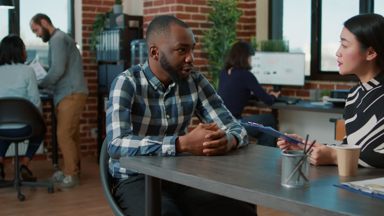 Asian recruiter interviewing male candidate about job offer