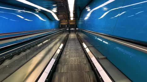 moving through a vibrant blue subway tunnel