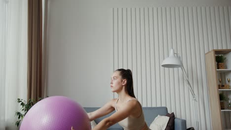 woman working out at home with an exercise ball