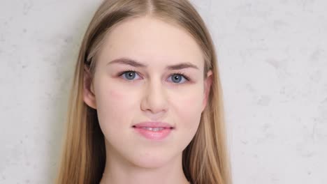 attractive european teenage girl smiling at the camera attractive european teenage girl smiling at the camera a beautiful teenage fashion model straightened her long hair while posing in the studio people style concept