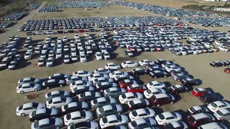 aerial perspective of new import cars sitting in a lot awaiting distribution and sale