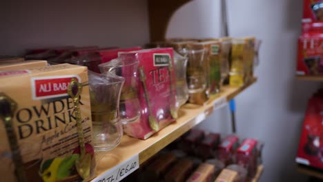 selection of turkish teas on sale on shelves inside shop. close up dolly
