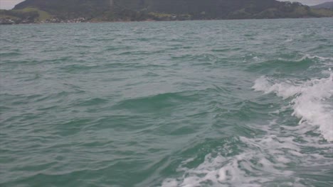 Slow-motion-of-a-dolphin-jumping-out-of-water-at-the-back-of-a-boat