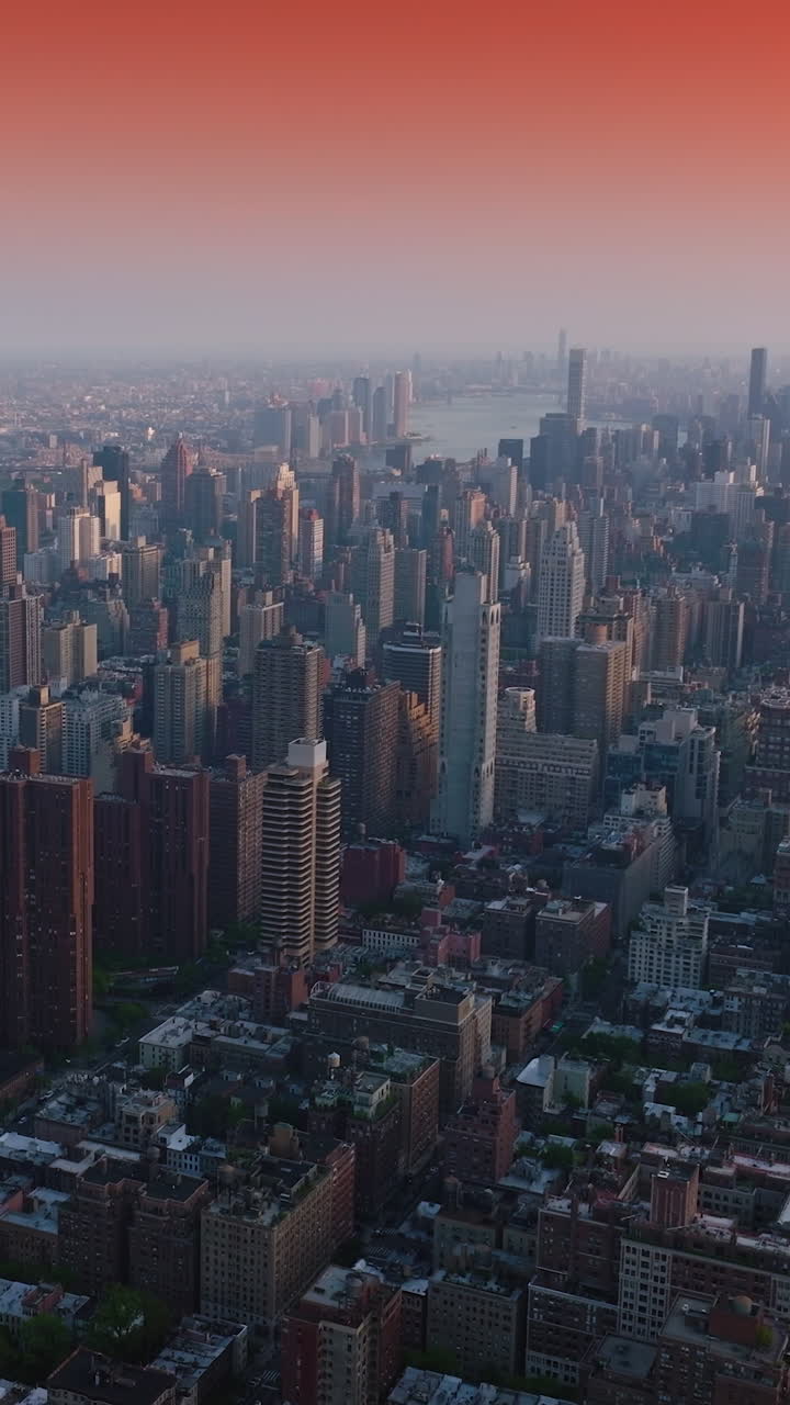 Impressive New York cityscape at sunrise. Beautiful quarters and streets of a metropolis. Pink sky backdrop. Vertical video