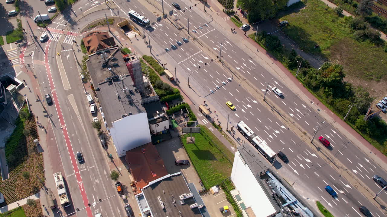 Aerial bird's eye view above street intersection in Gdynia Poland, public transport buses and cars drive at midday