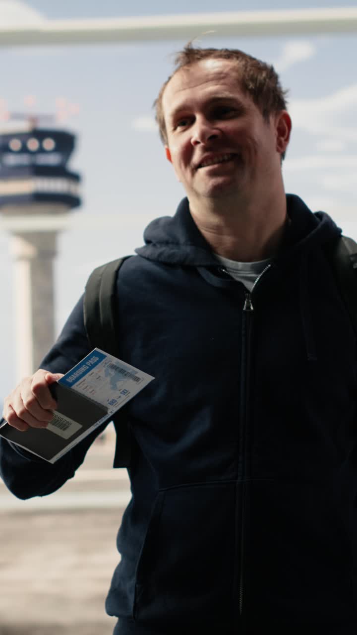 Vertical Video Man checking plane ticket and boarding pass standing in crowded airport