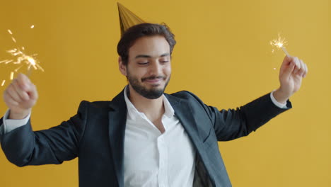 man celebrating with sparklers