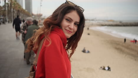 young girl smiling at the camera on the seafront