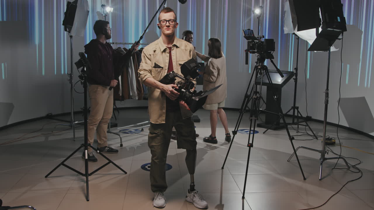 Portrait Of Cameraman With Crew In Filmmaking Studio