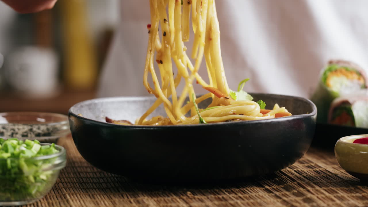 Close-up of Noodles with Vegetables and Spring Rolls