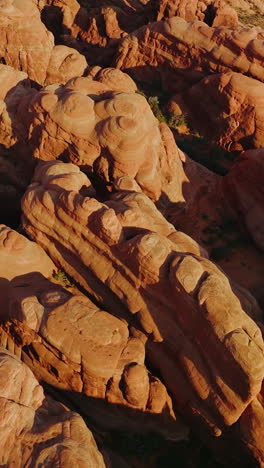 Strangely-shaped rocks in Arches National park in Utah, USA. Circling over a group of weird rocks in Canyons. Top view. Vertical video