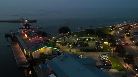 flying towards the restaurants on lakeshore drive near new canal lighthouse in new orleans, louisiana usa. aerial