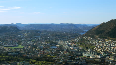 extra wide shot of bergen looking south with trees in foreground. filmed from fløyen panorama