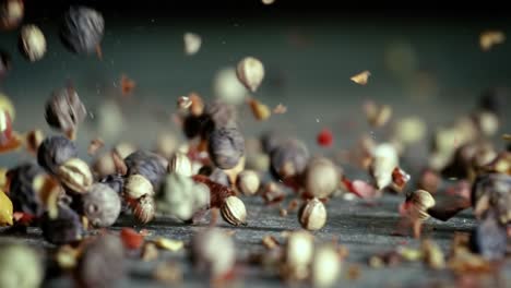 mixed peppercorns in a super slow motion. dry mix peppercorns close up.