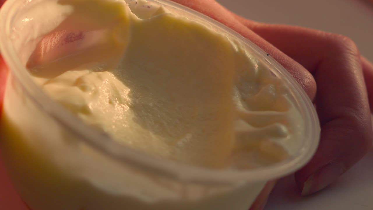 Spoon scooping Fresh Greek Yogurt in Natural Sunlight. Healthy, Organic Dessert. 4K