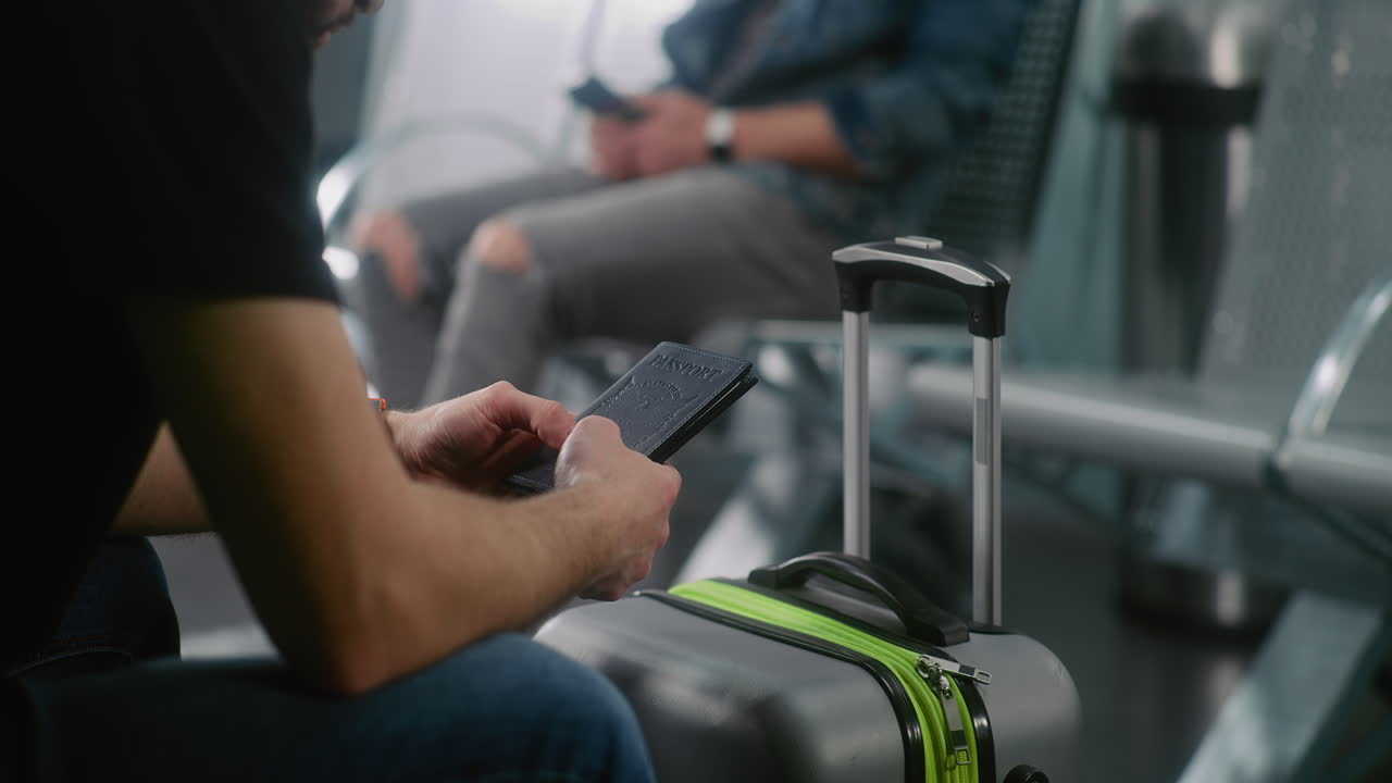 Person holding a passport and luggage at the airport