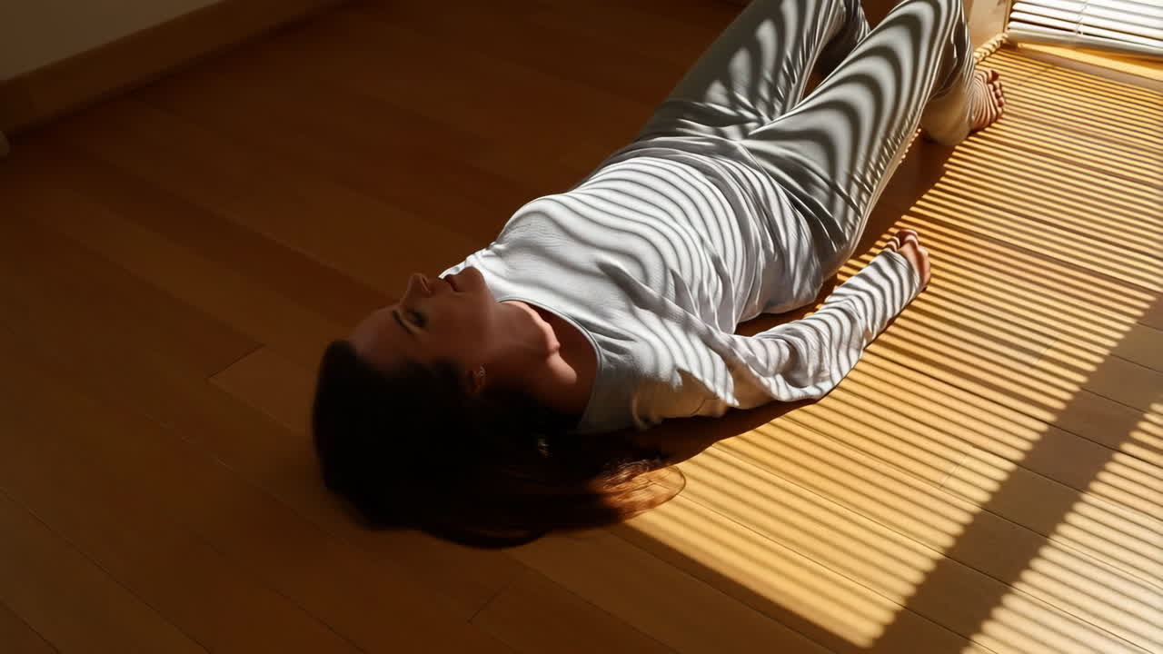 Woman lying on the floor in sunlight