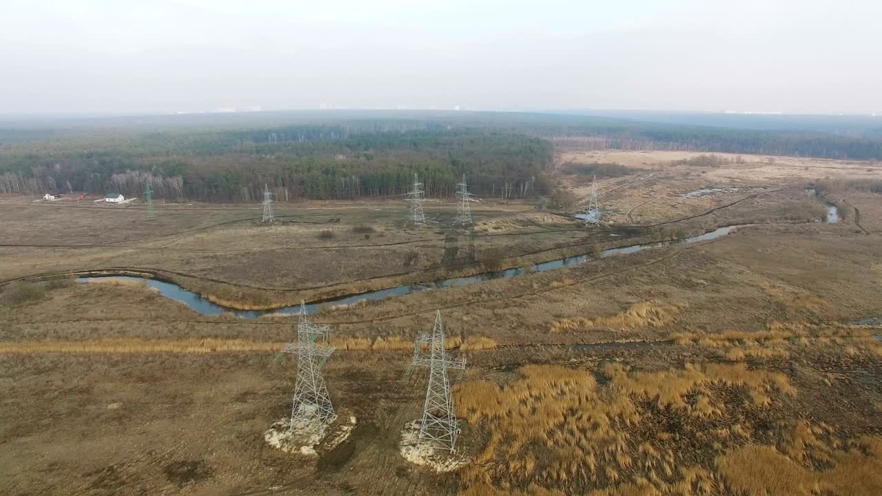 4k. antena. torres de línea de energía con cables en el campo de otoño.