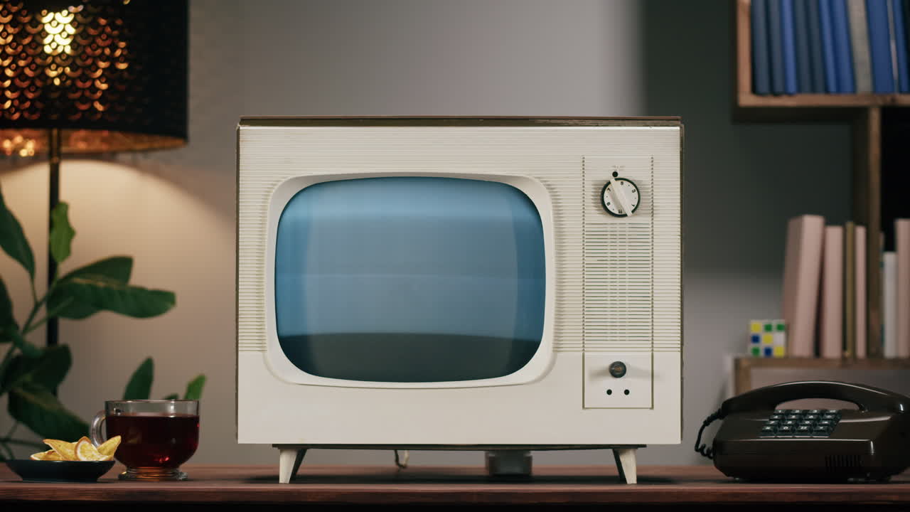 Retro television set on a table with other objects