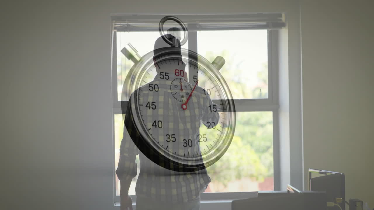 Standing by window, person using stopwatch animation overlay, focused on timing