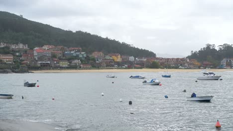 small boats on the shore at the fishing village of aldán, galicia