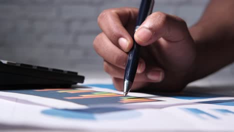 hand analyzing a chart with a pen