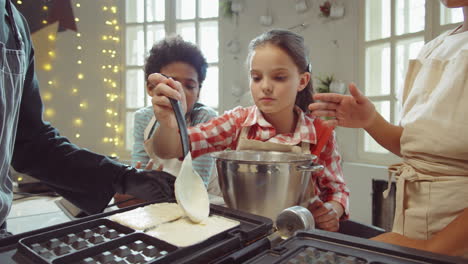 kids cooking waffles with chef on culinary masterclass