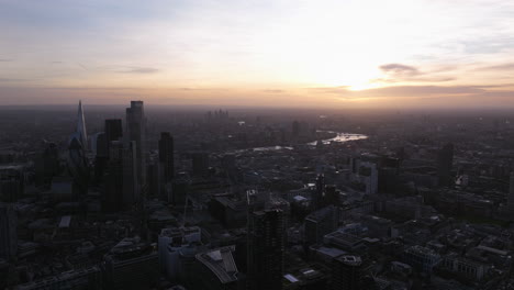 wide circling aerial shot of central london at dusk