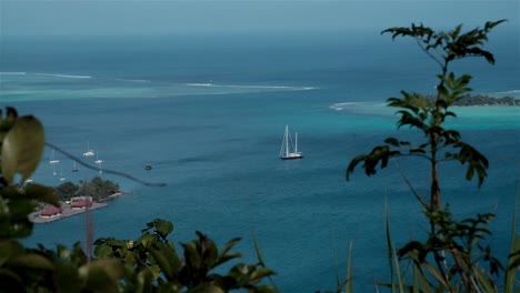 sailing super yacht at anchor in a sheltered bay in the south pacific