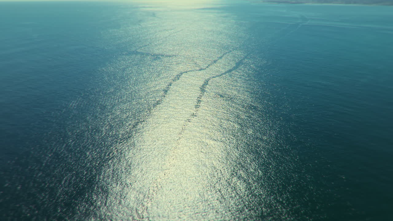 Aerial view of a calm sea reflecting sunlight